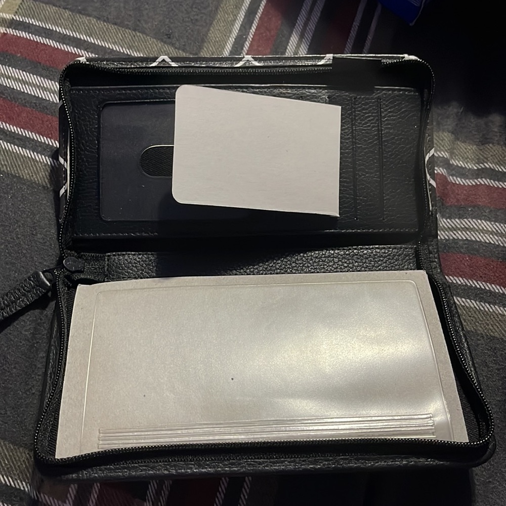 Barely used zip around checkbook cover in black/white with minor imperfections - Picture 6 of 6